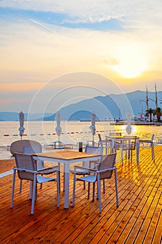 Open air cafe near the sea at sunset