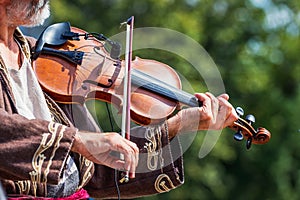 Open air concert. A professional musician performs a tune on a violin_