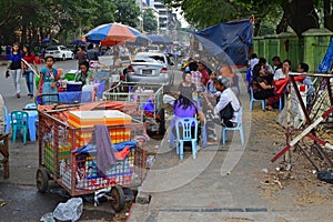 Open air hawker foodstall by the road side with tables and chairs