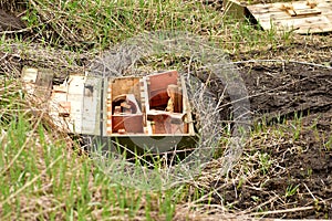 An open ammo box is on the ground. photo