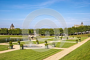 Open area with pond and fountain in the middle of famous renaissance park in chateau Villandry, Loire region, France.