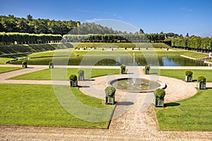 Open area with pond and fountain in the middle of famous renaissance park in chateau Villandry, Loire region, France.