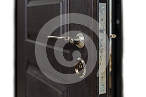 Open armored door. Door lock, Dark brown door closeup. Modern interior design, door handle. New house concept. Real estate.