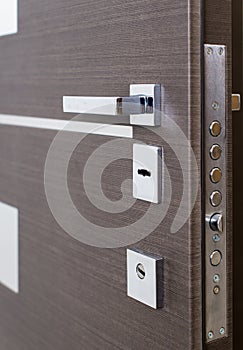 Open armored door. Door lock, Dark brown door closeup. Modern interior design, door handle. New house concept. Real estate. photo