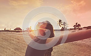 Open arms girl at sunset caribbean beach