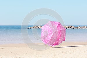 Open beach umbrella on the background of the sea