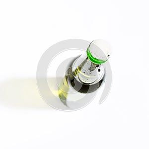 Open beer bottle with foam on white background