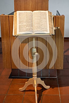 Open bible on a book stand in swiss reformation church