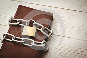 Open bible chained with lock