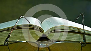 Open Bible with Glasses