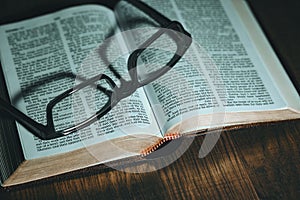 Open Bible with glasses on top