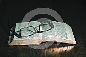 Open Bible with glasses on top