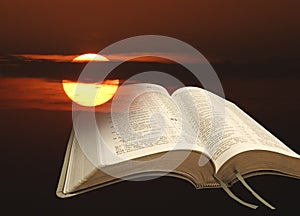 Open bible psalms holy word of god sunset sun heavens gospel photo
