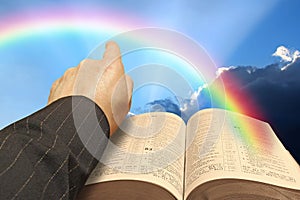 open bible rainbow blue sky clouds arm hand pointing god jesus christ heaven kingdom