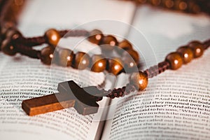 Open bible with rosary beads