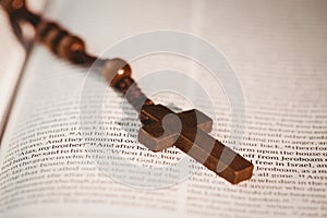 Open bible with rosary beads