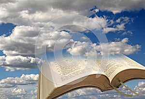 Open bible sky clouds background