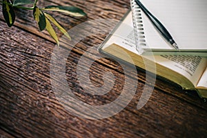 Open bible on wood desk with copy space.