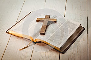 Open bible and wooden cross