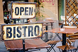 Open bistro sign at the empty caffe terrace
