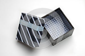 Open black gift box with ribbon and blue lines Top