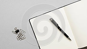 The notebook has a minimalistic design with plain unlined pages