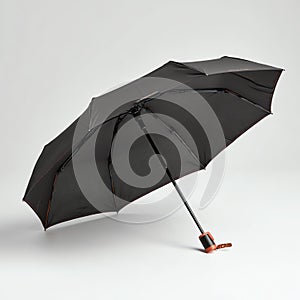 Open black umbrella on plain light surface