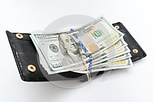 Open black wallet with dollars