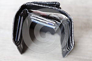 Open black woman wallet with money and id cards