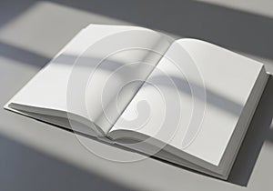 Open blank book with soft shadows and light on a textured surface