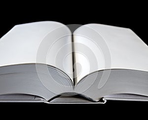 Open blank dictionary, book on black background
