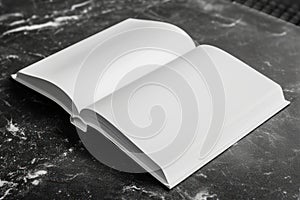 Open blank journal on dark textured surface