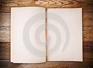 Open blank note book on old wood