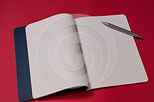 Open blank notebook with blue cover on a silver backgroun