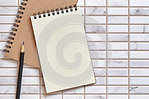 Open Blank Notebook and pencil on White Tile Background, Flat Lay Concept, Copy Space for Text, Top Table View