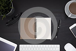 Open blank notebook spiral over black desk table