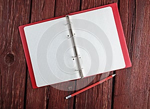 Open blank notepad with a pencil