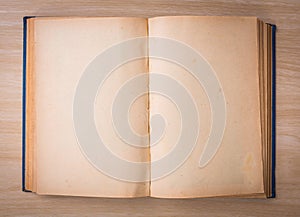 Open blank pages of old book on wood