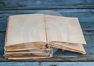 open blank pages of old book on wood background