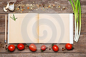 Open blank recipe book on brown wooden background