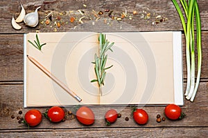 Open blank recipe book on brown wooden background