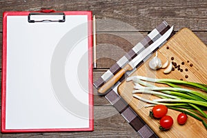 Open blank recipe book on brown wooden background