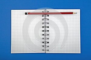Open blank of spiral notebook with pen