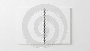Open blank spiral notebook on white background