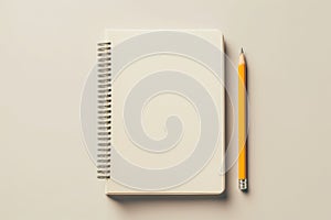 Open blank spiral paper notebook and yellow wooden graphite pencil on ivory background. Top view, copy space. Mockup
