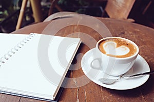Open a blank white notebook and cup of coffee