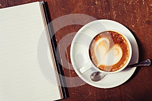 Open a blank white notebook and cup of coffee