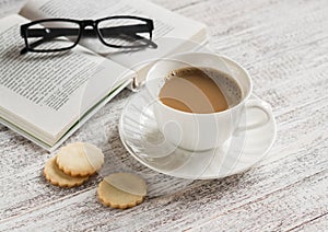 Open a blank white notebook, pen, women's bag, ruler, pencil and cup of coffee