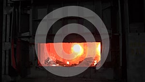 Open blast furnace at a steel factory. In the furnace, a huge temperature, the metal melted, the workers follow the