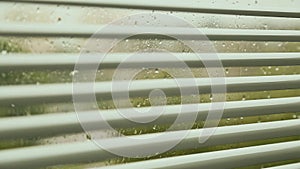 Open blinds on the window at the rainy weather